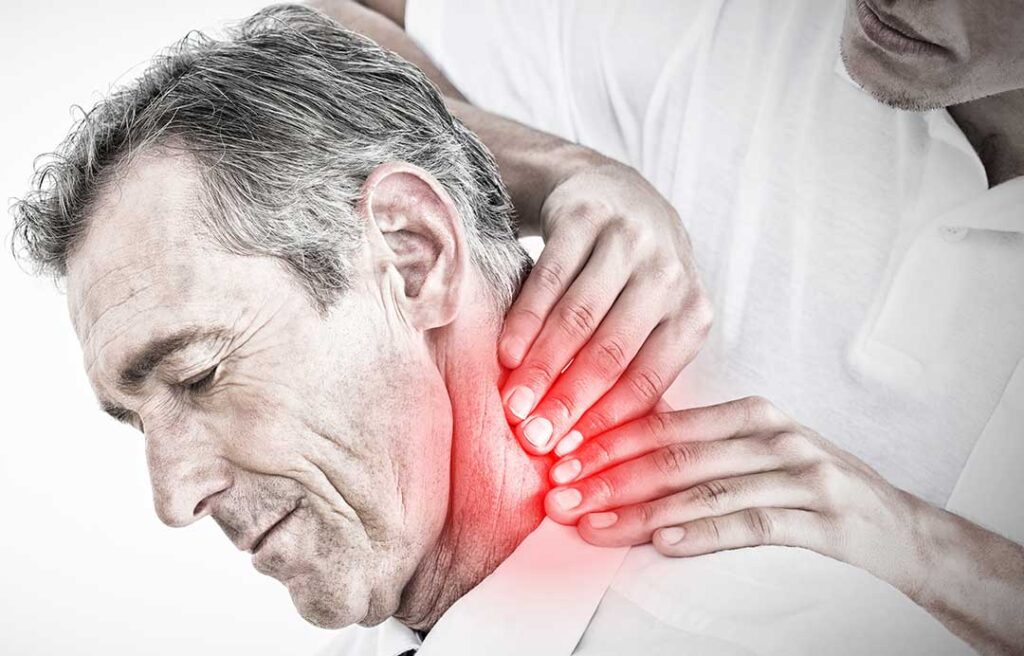 Person resting with a warm compress on the back after a chiropractic adjustment