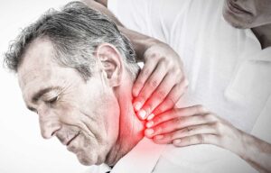 Person resting with a warm compress on the back after a chiropractic adjustment